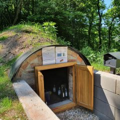 Erdkühlschrank mit geöffneter Tür und gekühlten Getränken